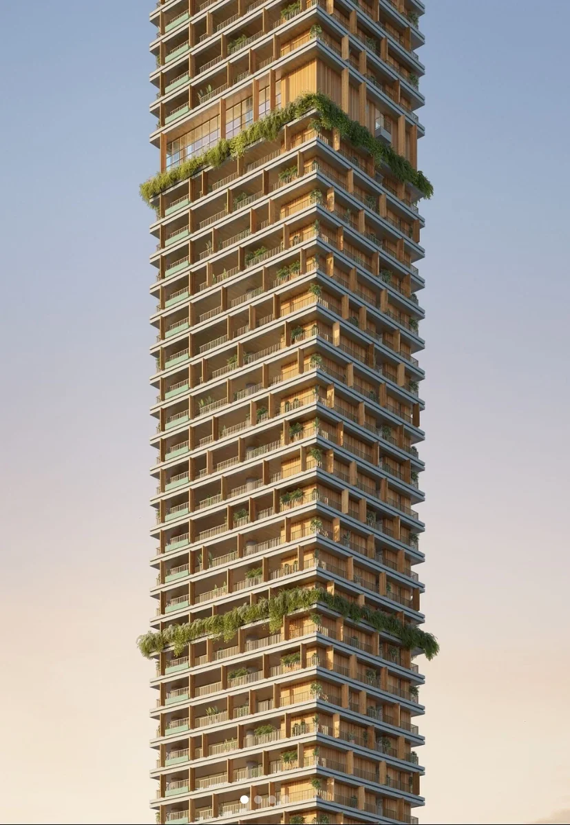 Legítimo Flamboyant: torre residencial com fachada em madeira, varandas e faixas de jardins pendentes, ao entardecer